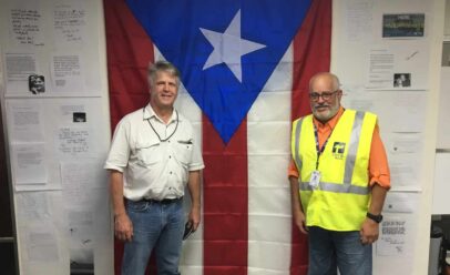 Wagoner poses in front of a Puerto Rican flag with TOTE VP.