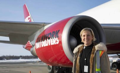Betsy Seaton stands in front of a NAC jet engine.