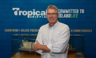 Jeff poses in front of a Topical ship model and mural.