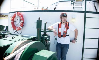 Castner leans on a handwheel aboard the Henry Foss.