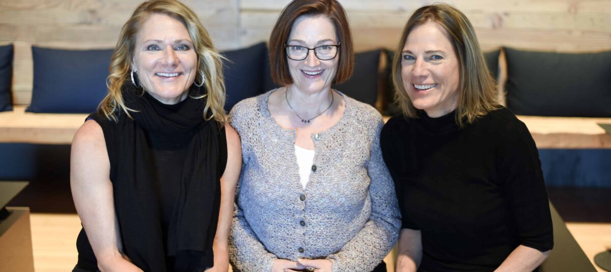 From left, Nicole Michele and Denise lean in together for a photo.