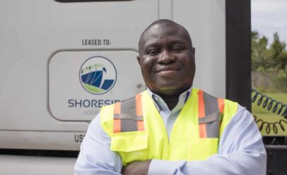 Will smiles and crosses his arms in front of a Shoreside cab.