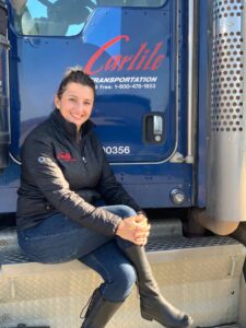 Elinor Harrington sitting on a truck step