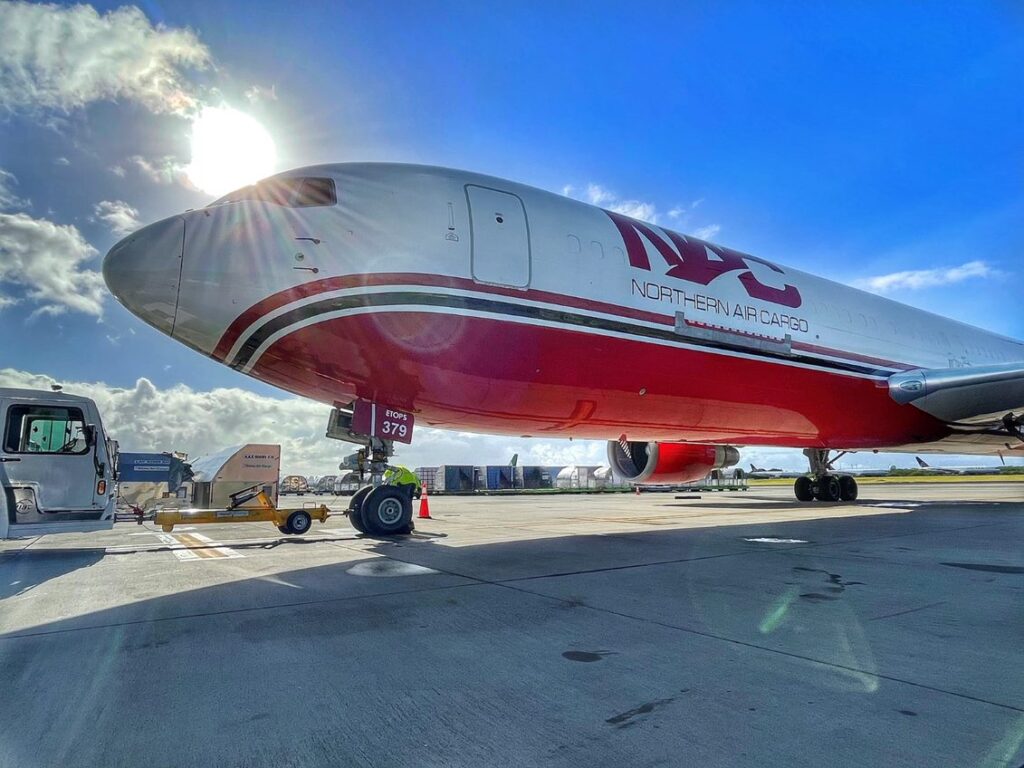 NAC airplane with the sun shining behind it