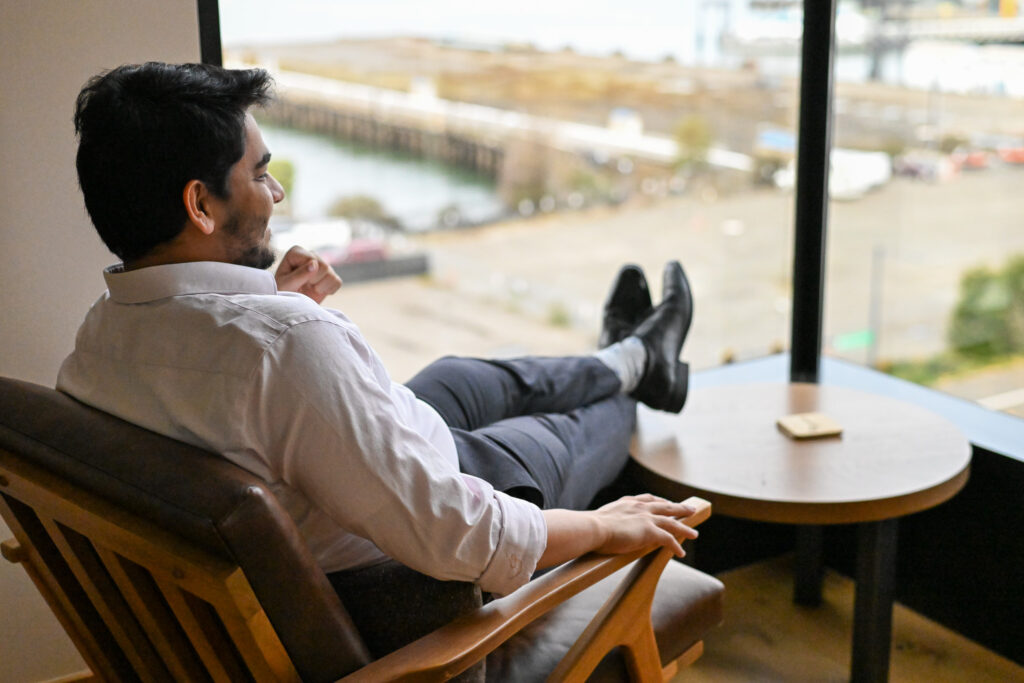 Shah looking out at the Seattle waterfront from the NorthStar Energy corp office