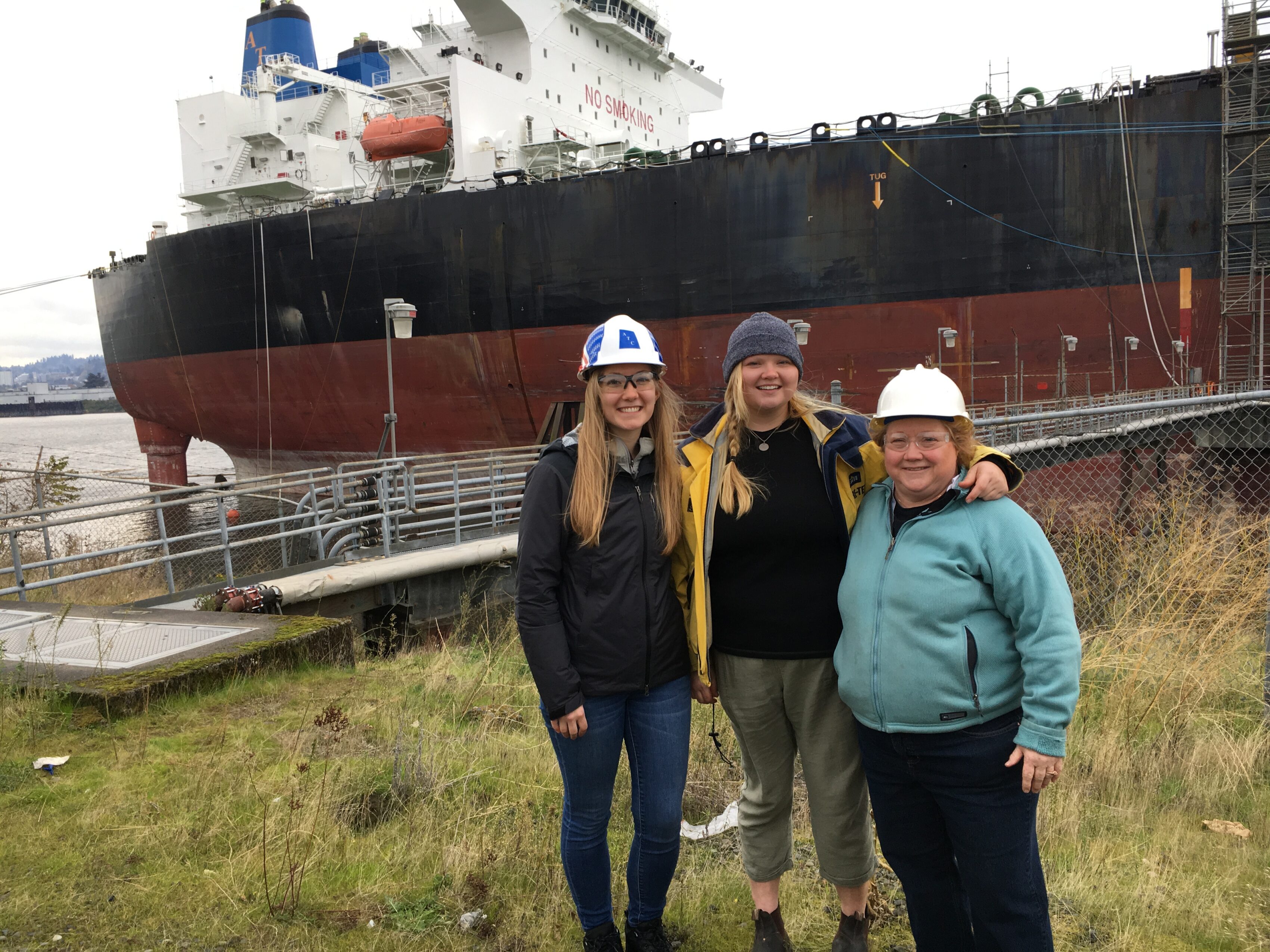 Hays with her daughters standing in front of an ATC vessel